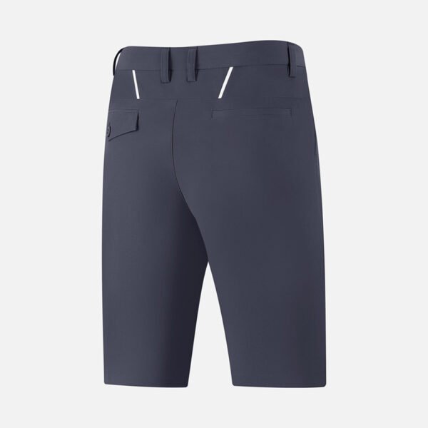 Male golfer wearing white custom performance shorts during a follow-through swing.