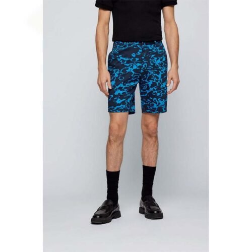 Vibrant tropical print custom golf shorts displayed against a summer background.