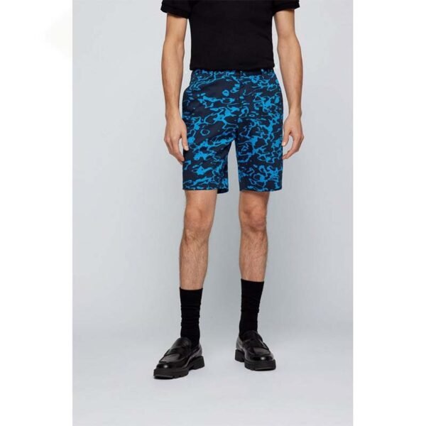 Vibrant tropical print custom golf shorts displayed against a summer background.