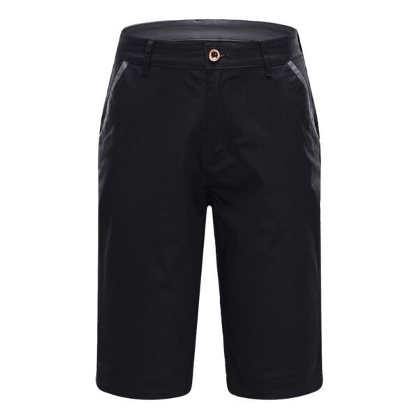 Golfer walking through tall wet grass in grey Element-Shield shorts.