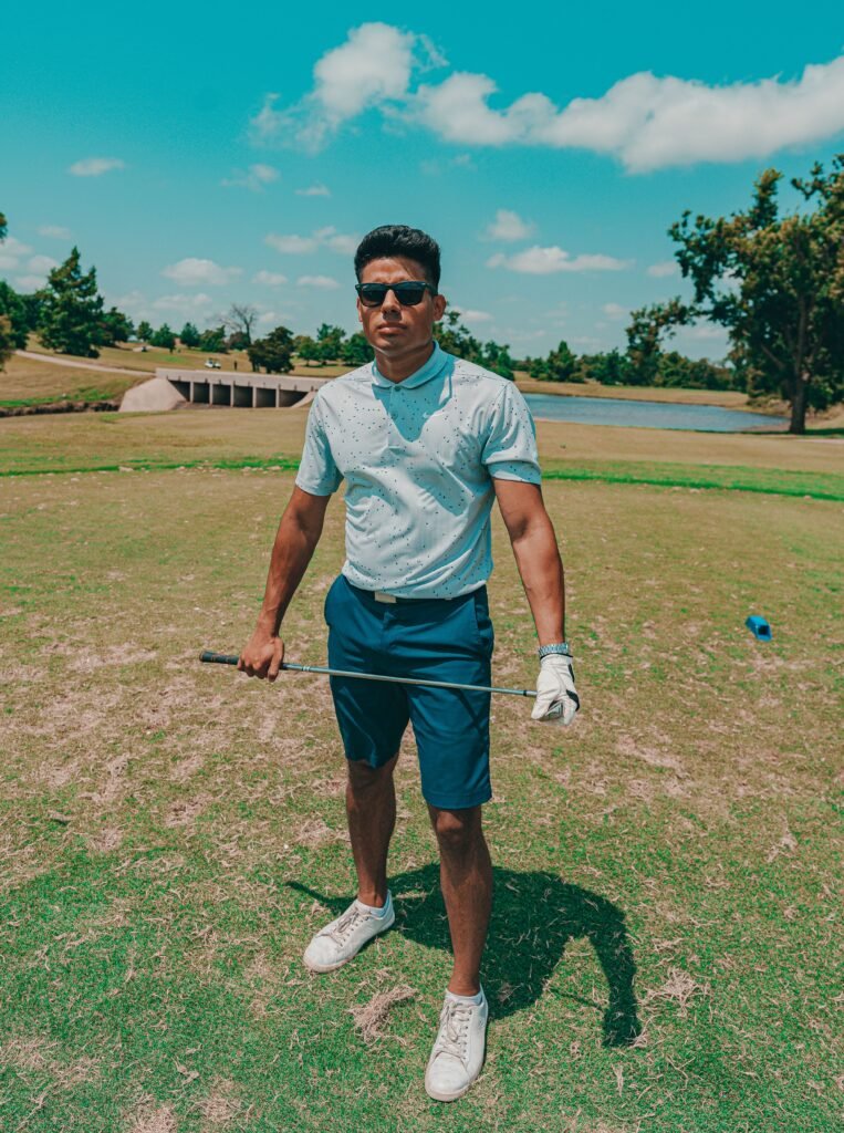 Confident golfer holding club on a sunny day at Oklahoma City golf course.