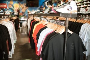 Vibrant display of trendy clothing and shoes in an urban boutique setting.